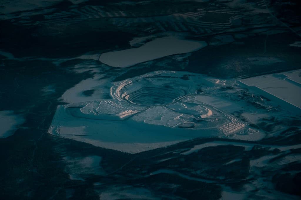 Snow-covered open-pit mine aerial